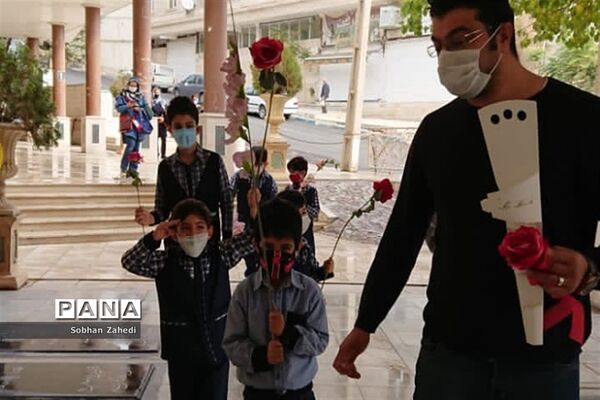 غبارروبی مزارشهدا توسط دانش‌آموزان رودهن در دهه فجر