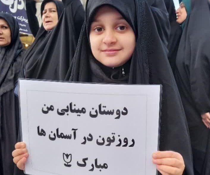 دخترانِ انقلابی پای پرچم ایستاده‌اند